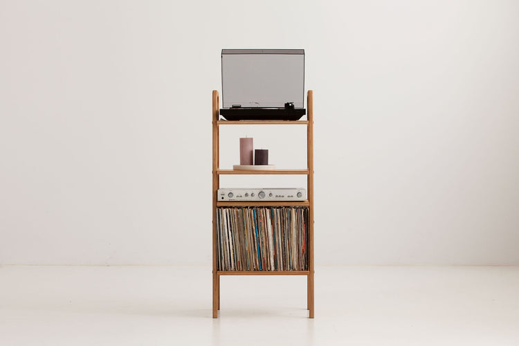 Three-quarter view of the mid-century record player stand showing turntable, display shelf, amplifier shelf and LP storage bay, wooden bookshelf