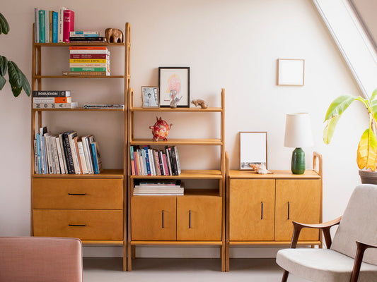 Modular plywood shelving system in light oak finish across 222 cm wall