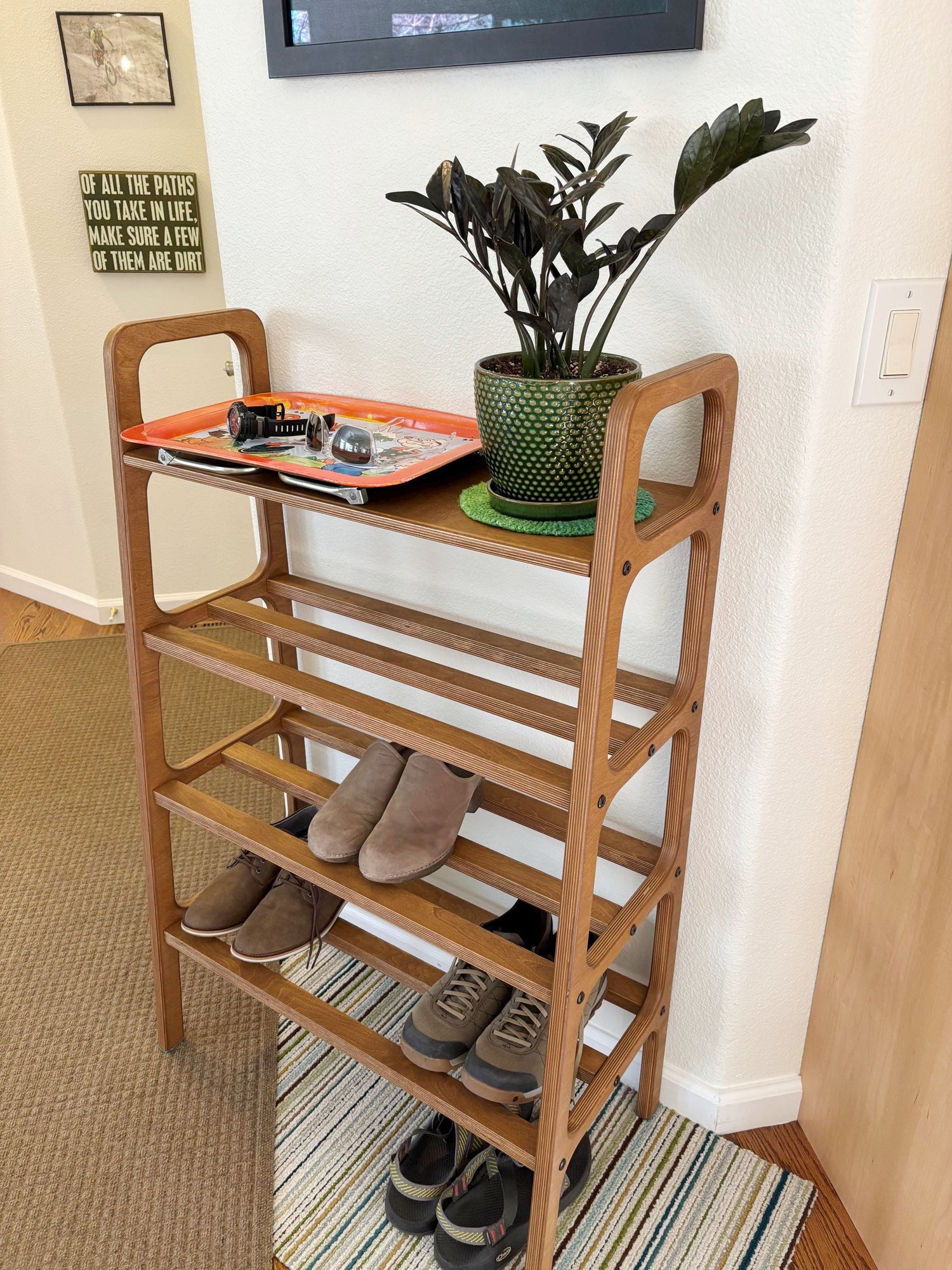 Tall walnut plywood shoe rack customized for a narrow wall in Fort Collins entryway