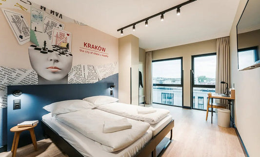Plywood stool used as bedside table in Meininger Hotel room in Kraków