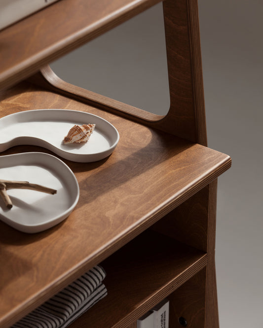 Close-up of the walnut-stained birch plywood shelf and rounded ladder frame of the Maxi bookcase