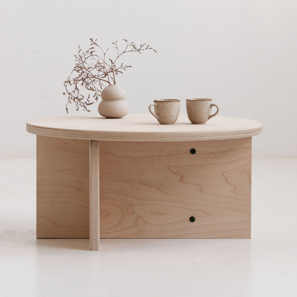 Minimalist Japandi coffee table Europe with round plywood top and lower shelf for books