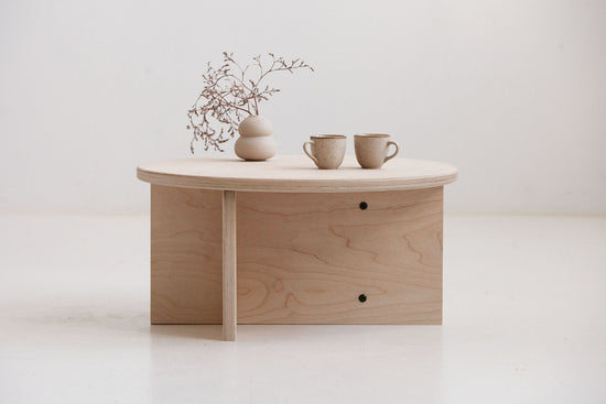 Minimalist Japandi coffee table Europe with round plywood top and lower shelf for books
