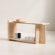 Minimalist wooden shelf with a few items on a plain background