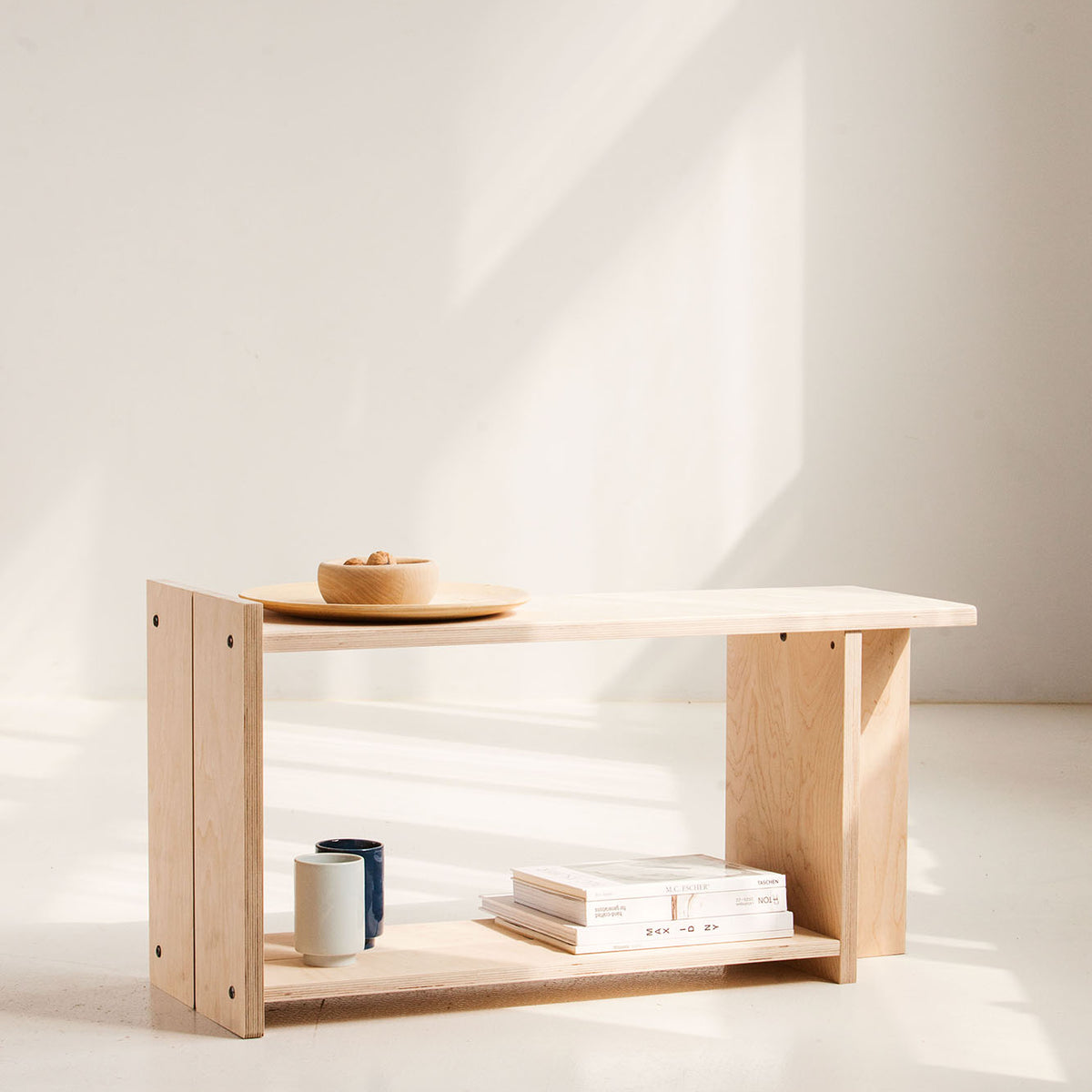 Wooden shelf with minimal decor on a white background
