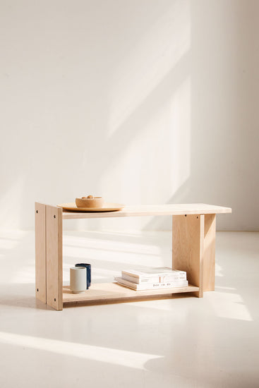 Wooden shelf with minimal decor on a white background