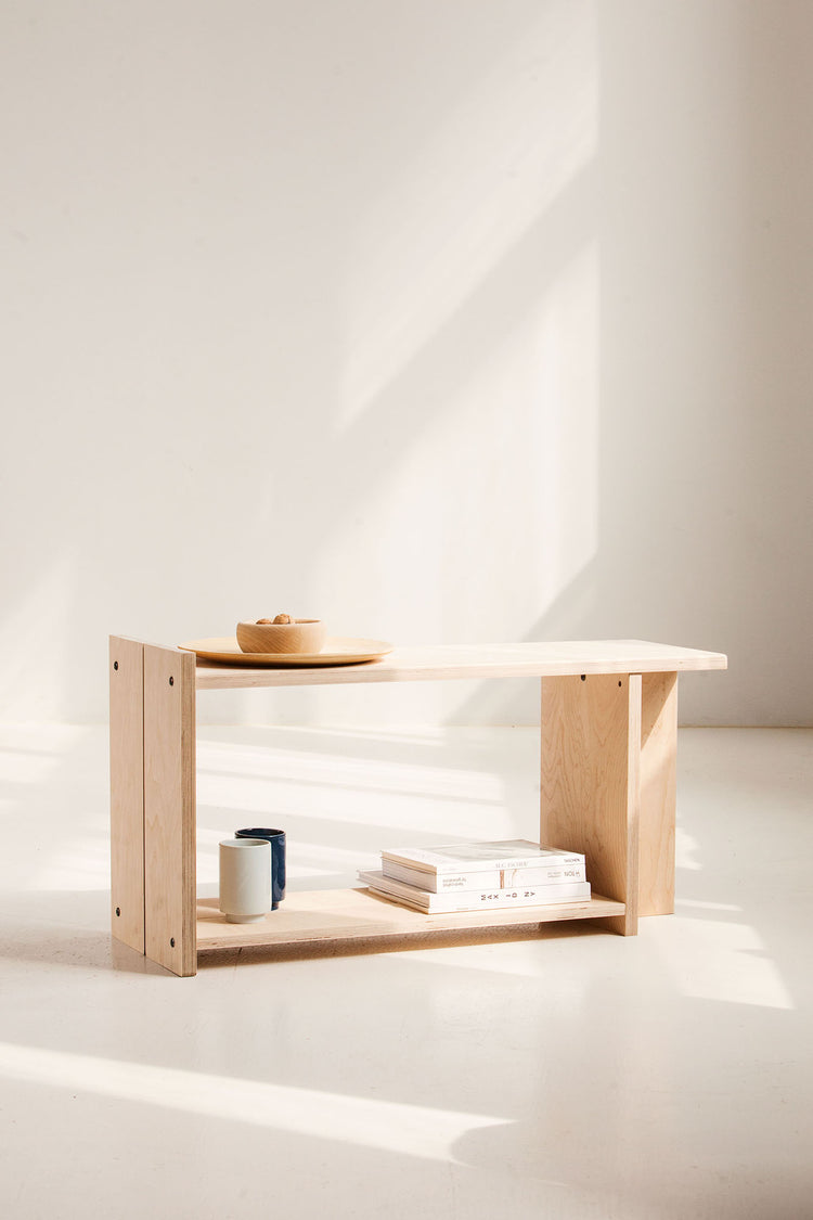 Wooden shelf with minimal decor on a white background