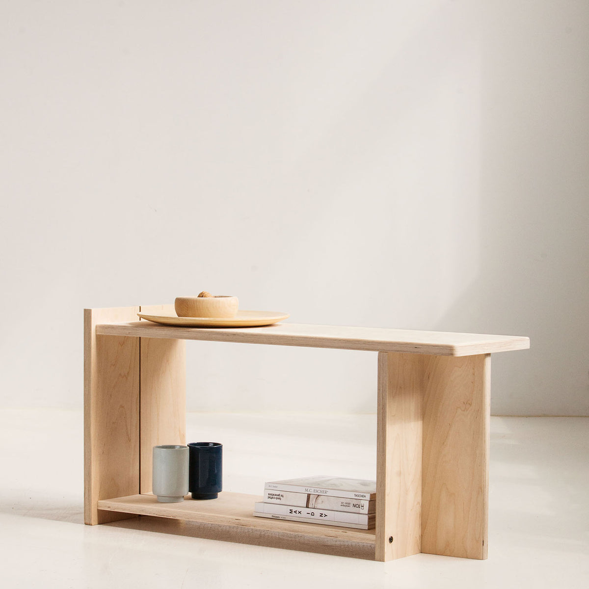 Wooden shelf with a minimalistic design against a plain background