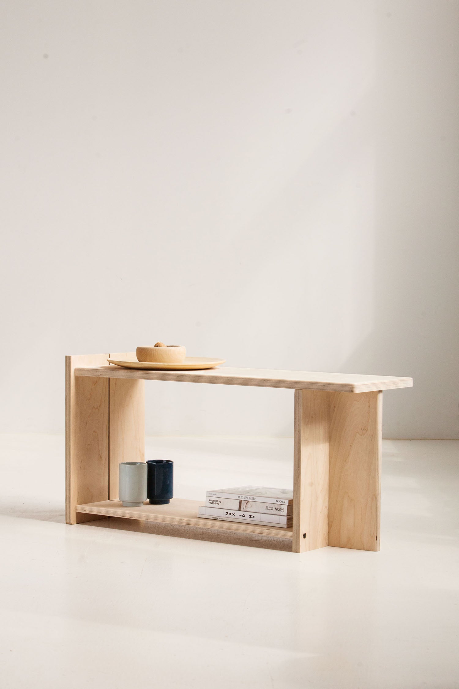 Wooden shelf with a minimalistic design against a plain background
