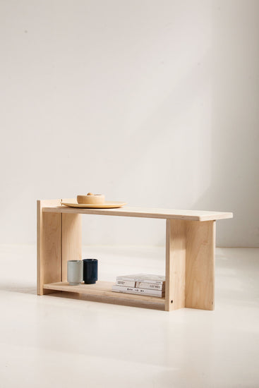 Wooden shelf with a minimalistic design against a plain background