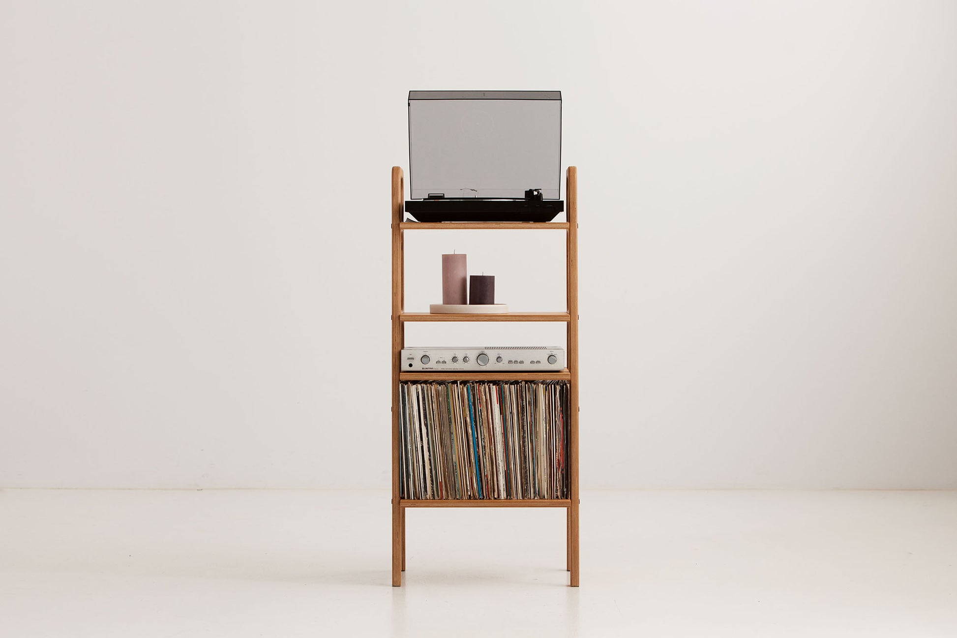 Three-quarter view of the mid-century record player stand showing turntable, display shelf, amplifier shelf and LP storage bay, wooden bookshelf