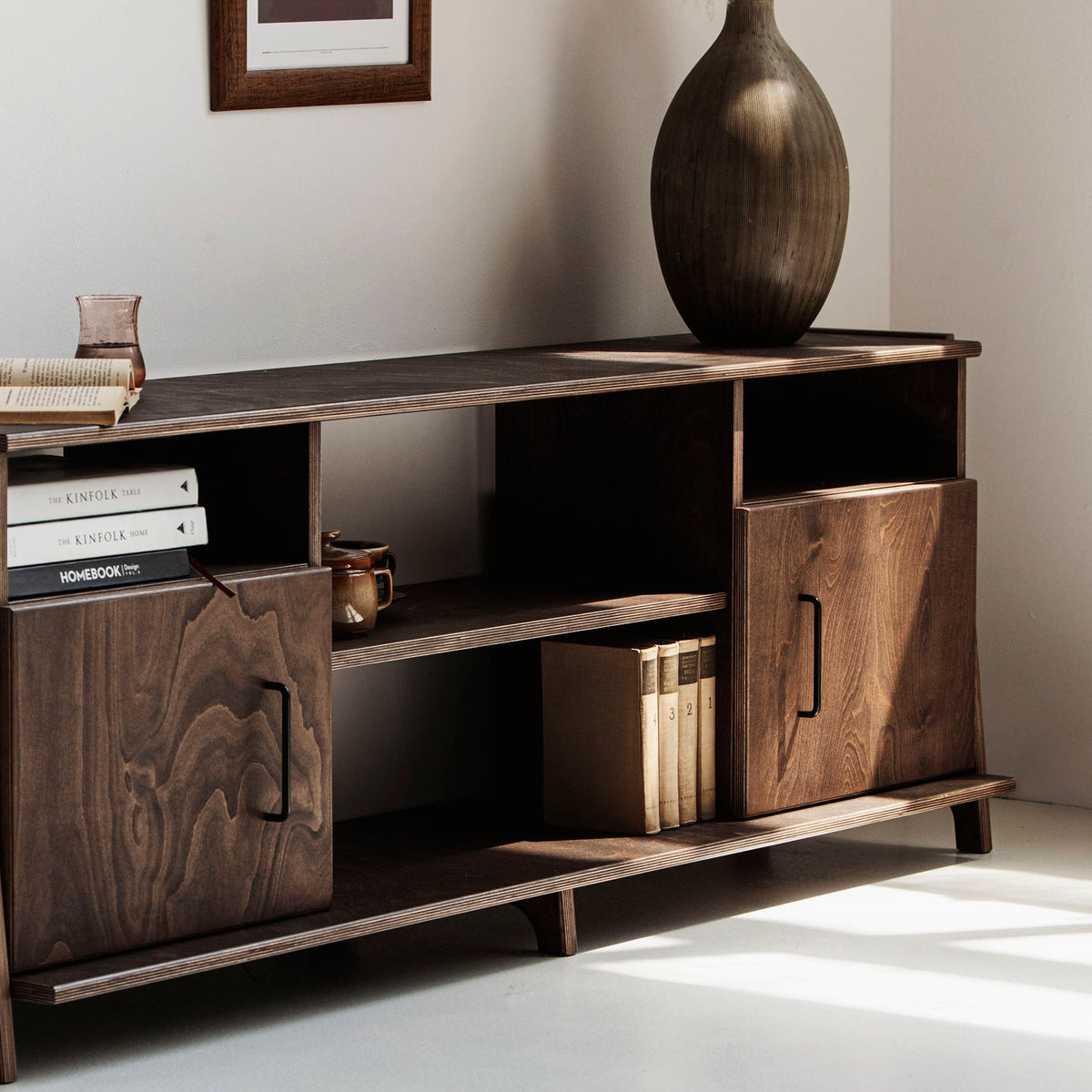 Mid-century TV stand and media console with two cupboards and open shelves in dark wood finish