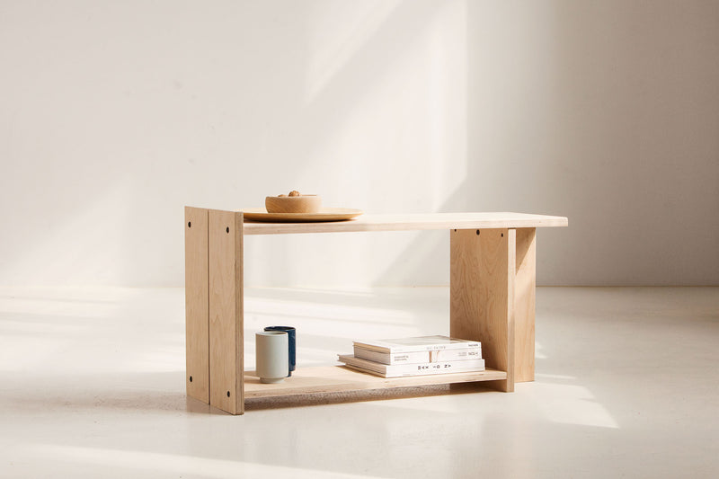 Wooden shelf with books and a bowl on a white background