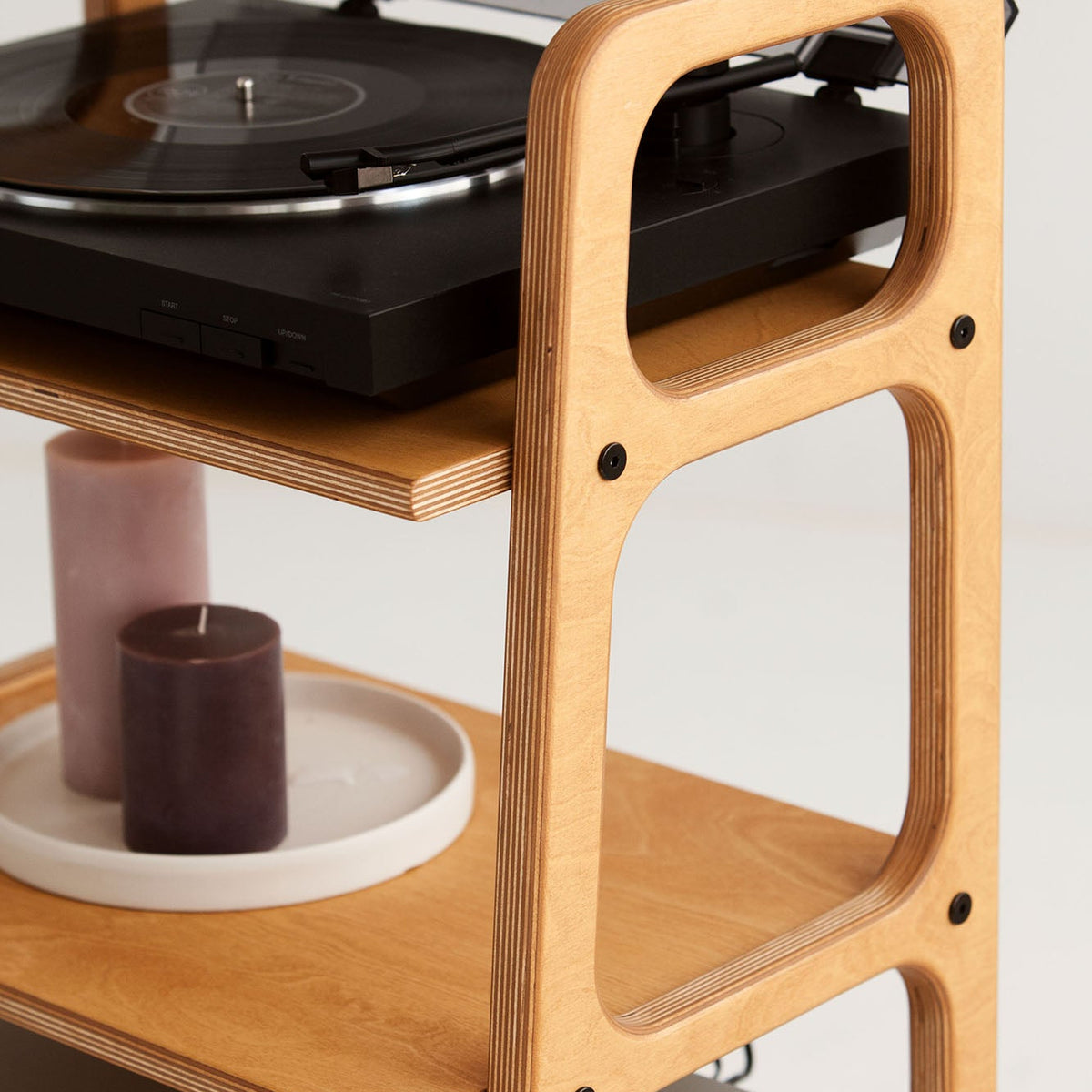 Close-up of the top turntable shelf and rounded wooden frame on the mid-century record player stand.