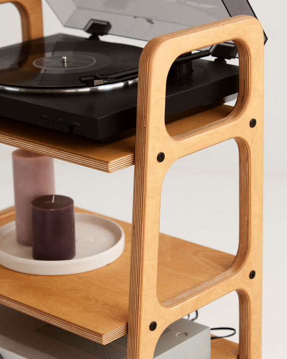 Close-up of the top turntable shelf and rounded wooden frame on the mid-century record player stand.