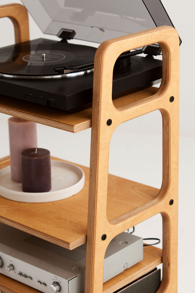 Close-up of the top turntable shelf and rounded wooden frame on the mid-century record player stand.