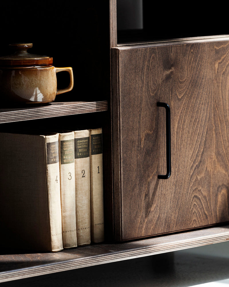 Top view of mid-century wooden TV stand with decorative vase and books